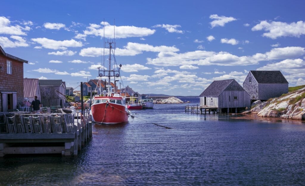 Boats docked at the wharf on a beautiful summer's day in Nova Scotia's iconic fishing community of Peggy's Cove.